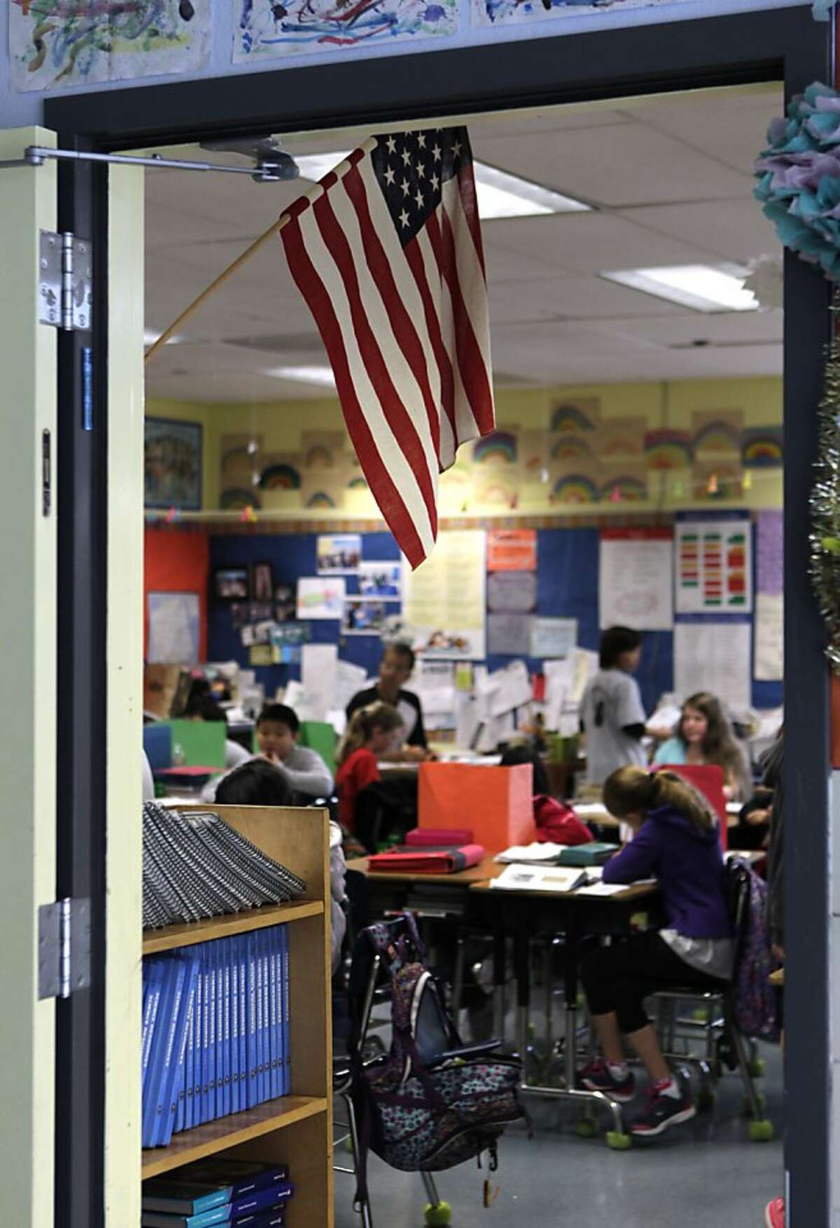 The U.S. flag hangs in David Allyn's 5th-grade classroom at Argonne Elementary School in San Francisco, Calif. on Friday, March 15, 2013. Students at Argonne recite the Pledge of Allegiance during bi-weekly assemblies on the schoolyard.