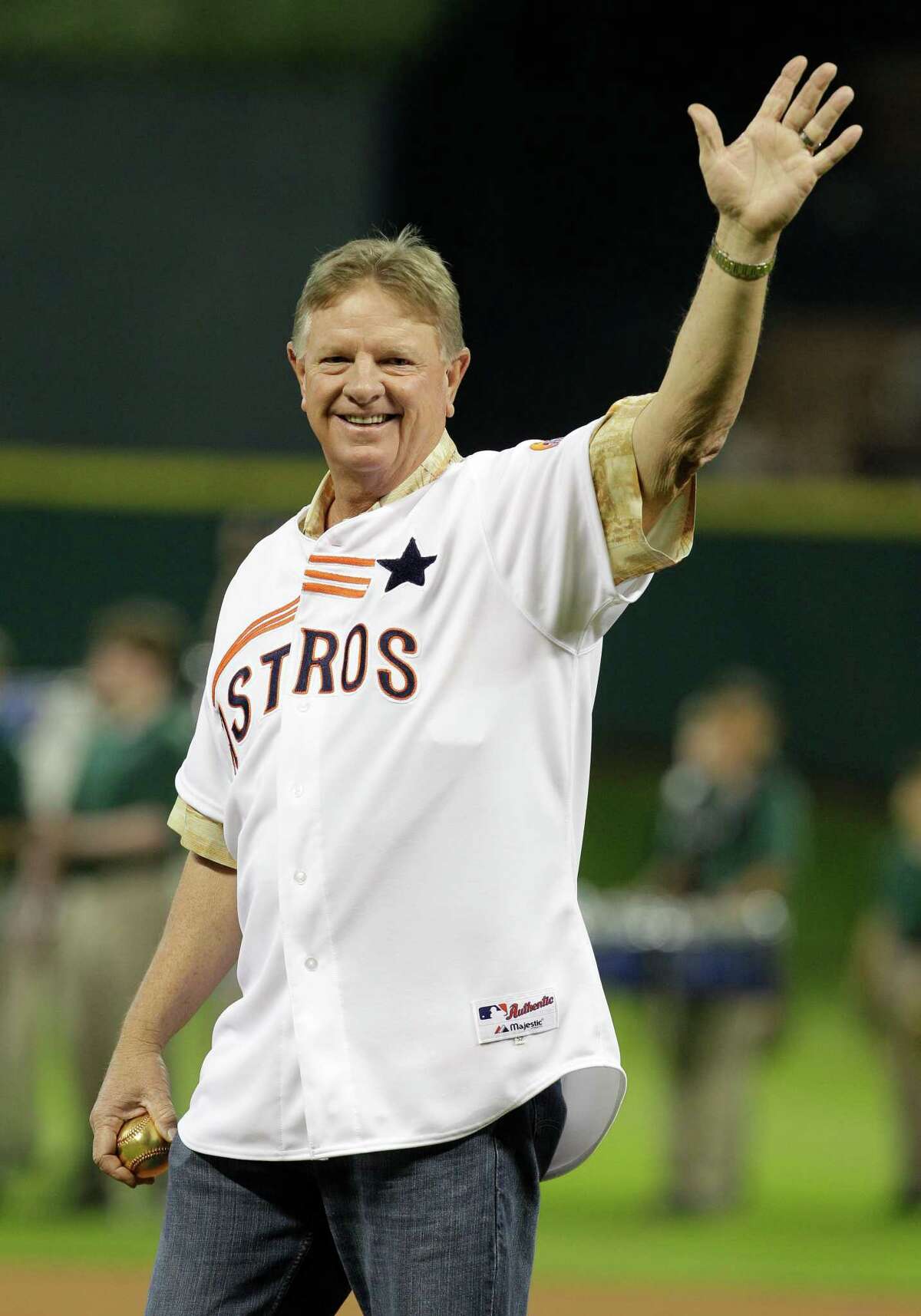 Former Houston Astros' Larry Dierker throws out a first pitch before game against the Los Angeles Dodgers Friday, April 20, 2012, in Houston. He used a ceremonial 24-karat gold leather cover baseball. ( Melissa Phillip / Houston Chronicle )