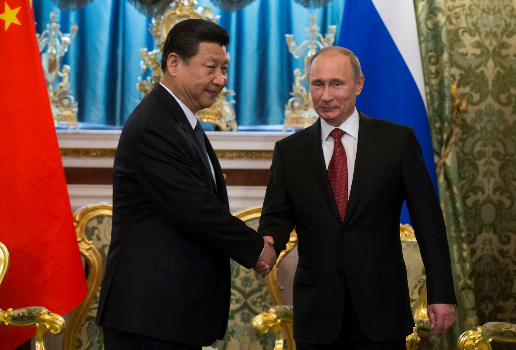 In lavish reception, Putin greets China president