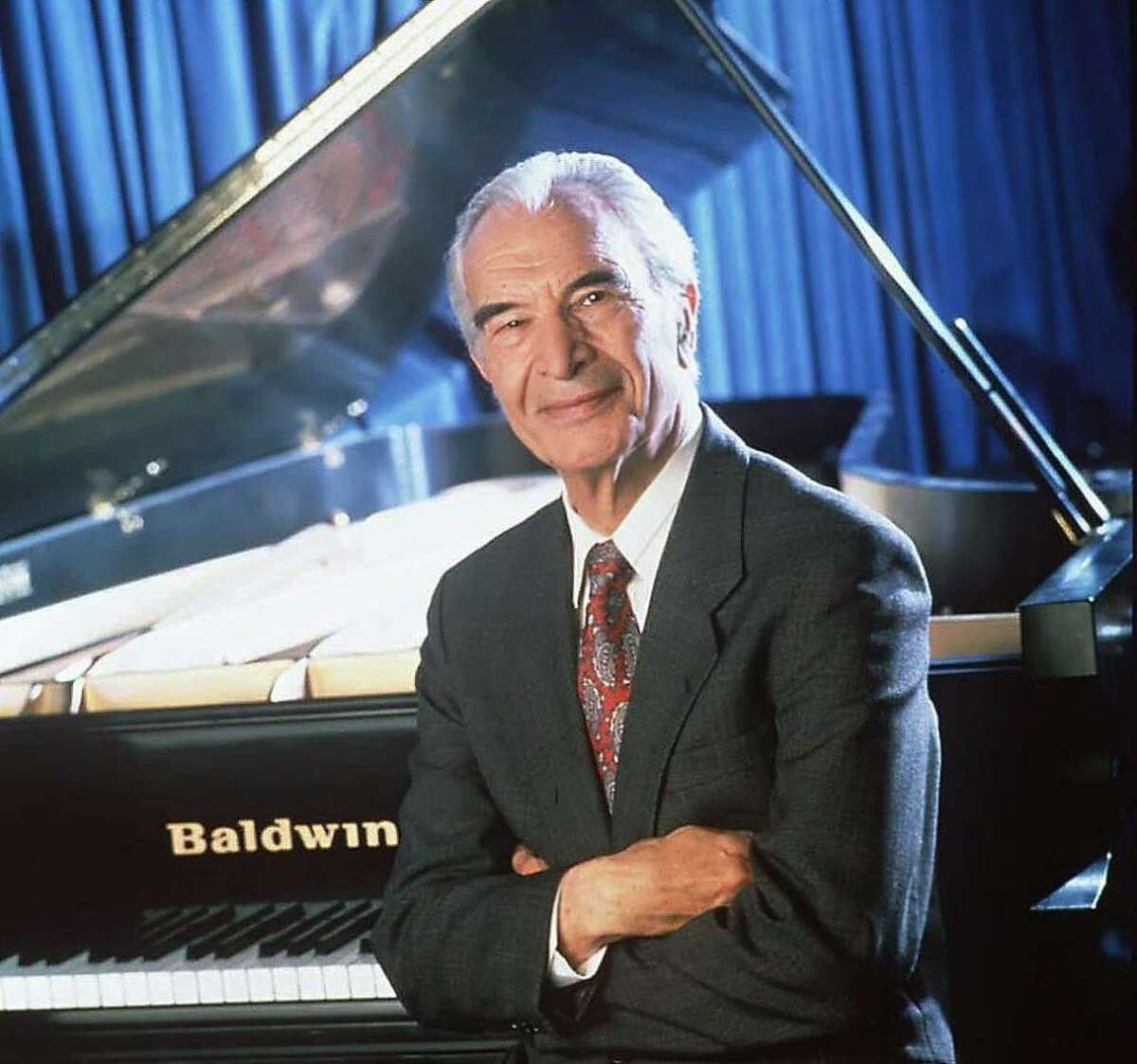 Dave Brubeck posed by a piano. Brubeck, a pianist, was a 2009 Kennedy Center Honoree.