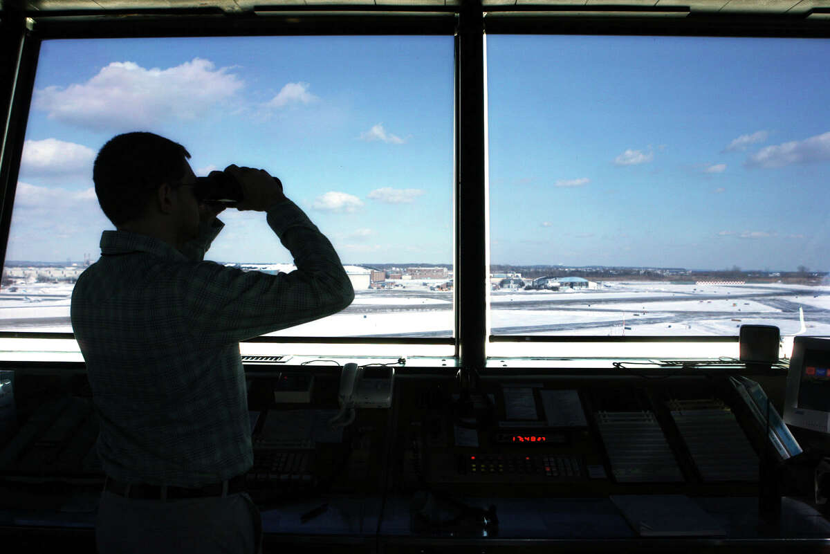 Air Traffic Control Specialist Eric Lanier checks on an incoming plane from the tower at Sikorsky airport in Stratford. 1/16/09