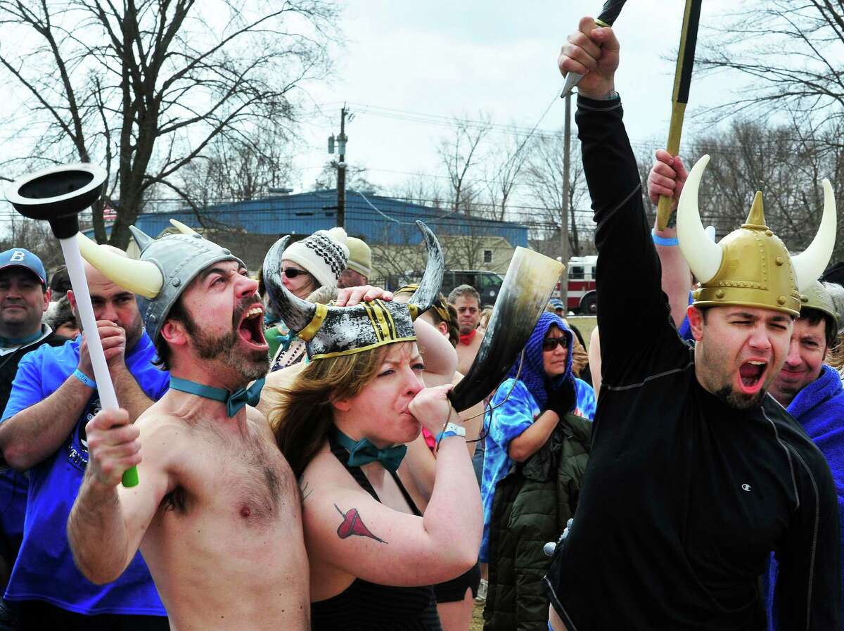 Dan Newton, left, Meghan Halloran and Alex Mastroianni get psyched for the Penguin Plunge into Candlewood Lake at the Danbury Candlewood Park, in Conn. Saturday, March 23, 2013. The event was a fundraiser for local charities including the Connecticut Special Olympics.