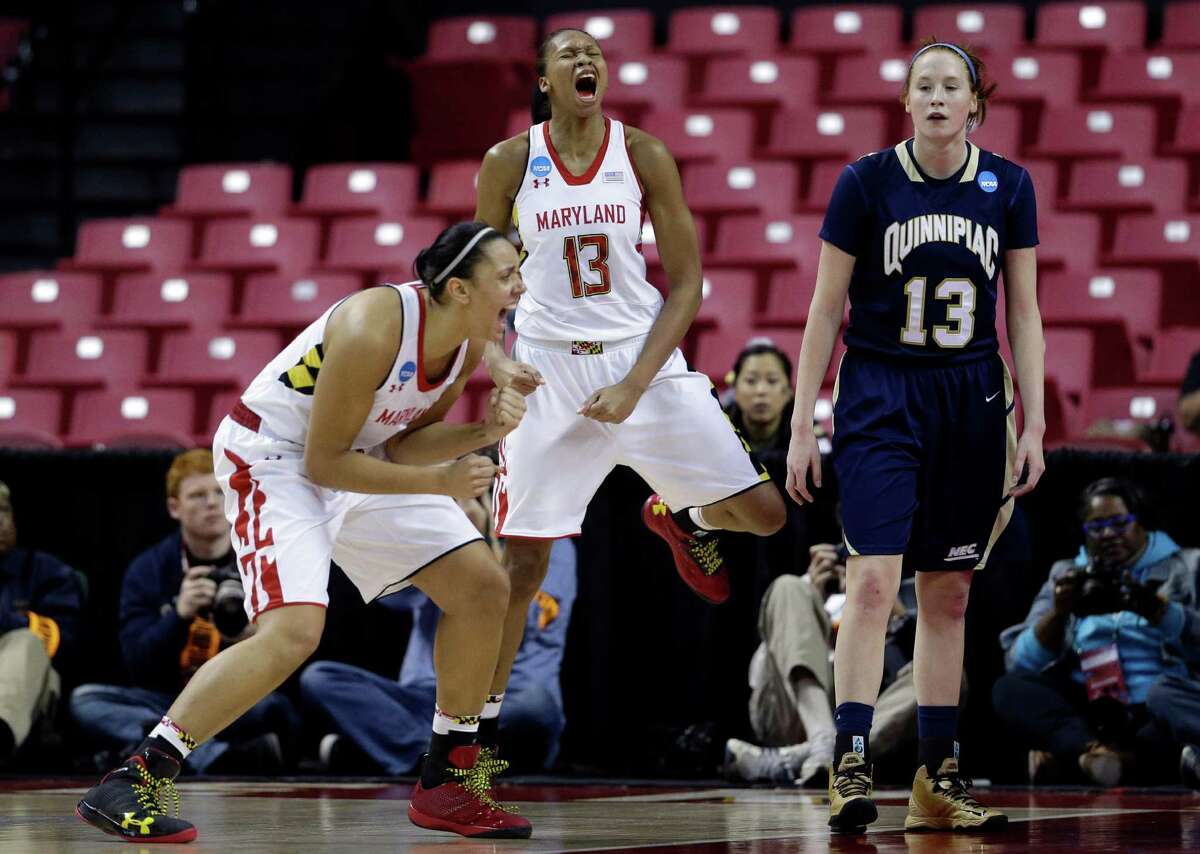 Maryland's Malina Howard, left, and Alicia DeVaughn, center, celebratea alongside Quinnipiac forward Camryn Warner after DeVaughn was fouled as she scored a basket during the first half of a first-round game in the women's NCAA college basketball tournament in College Park, Md., Saturday, March 23, 2013.