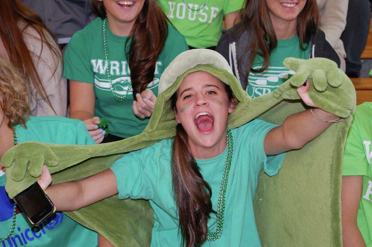 Lily Powers, 17, gives it up for the green Wright House Alligators at Friday's Battle of the Houses at Fairfield Ludlowe High. "I like being in Wright House, because we're like the underdogs, but we're gonna win this year, my senior year," she said. FAIRFIELD CITIZEN, CT 3/22/13