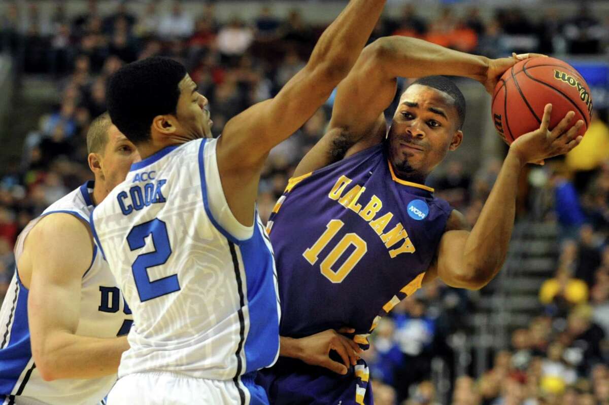 UAlbany's Mike Black, right, tries to pass around Duke's Quinn Cook during their second round NCAA Tournament on Friday, March 22, 2013, at Wells Fargo Center in Philadelphia, Penn. (Cindy Schultz / Times Union)