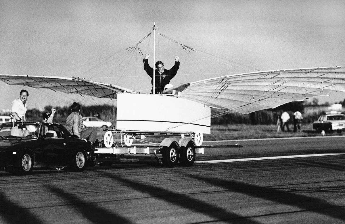 Actor Cliff Robertson signals success after he test-piloted a replica of an airplane challenging the Wright brothers' status as the first to fly on Friday morning, July 11, 1986 in a tethered test flight at Sikorsky Memorial Airport in Stratford, Conn. The aircraft, in the test flight, rose off the trailer while being towed. Its builders want to prove that Gustave Whitehead a Connecticut Aviation pioneer, flew in 1901. (AP Photo/Peter Hvizdak)
