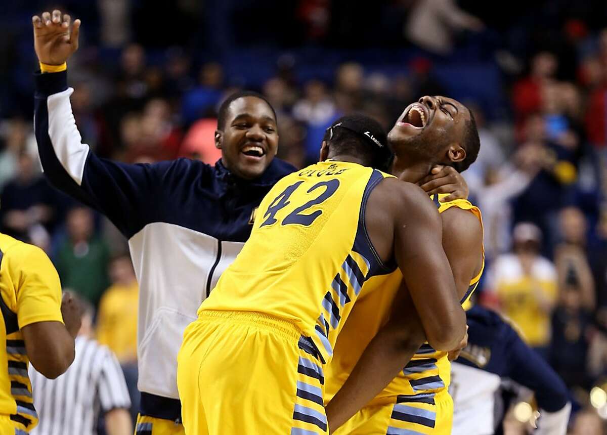LEXINGTON, KY - MARCH 23: Davante Gardner #54 and Chris Otule #42 of the Marquette Golden Eagles celebrate with teammates after defeating the Butler Bulldogs during the third round of the 2013 NCAA Men's Basketball Tournament at Rupp Arena on March 23, 2013 in Lexington, Kentucky. (Photo by Andy Lyons/Getty Images)