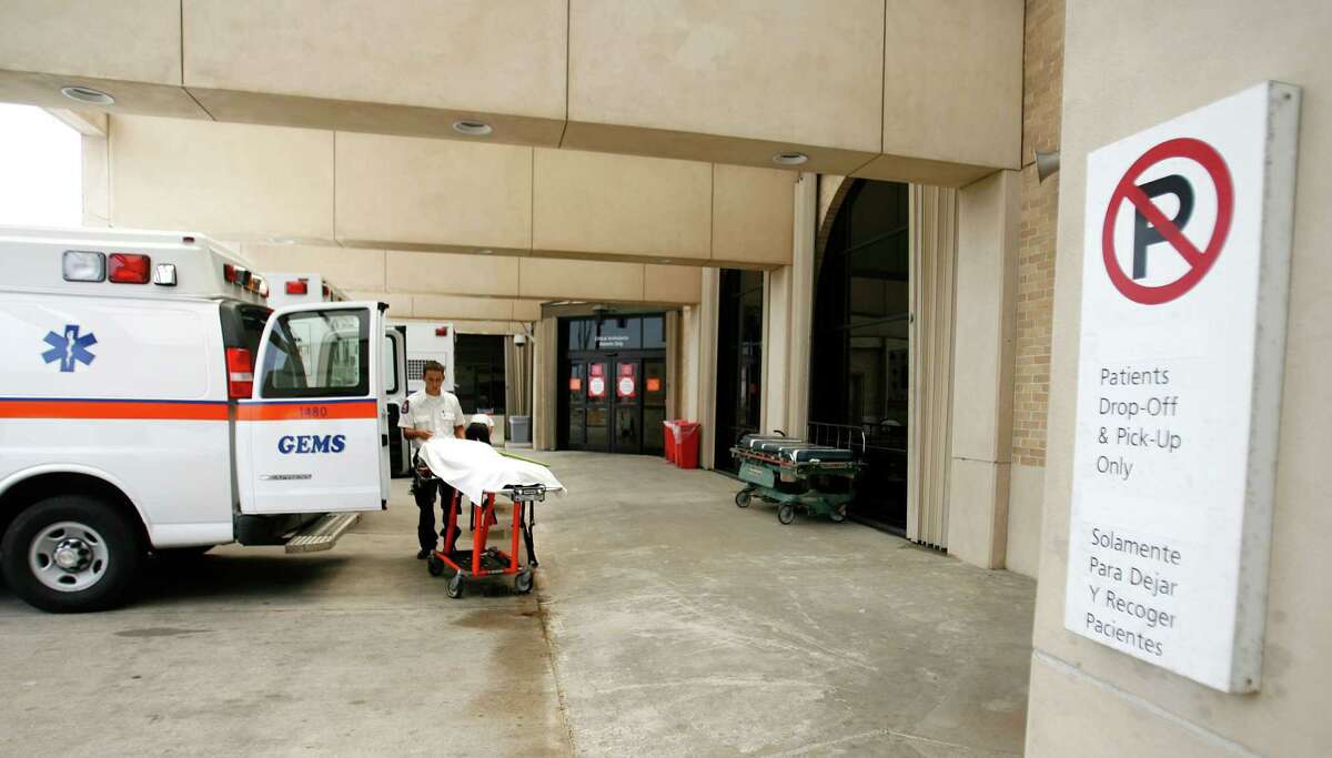An EMT with Galveston EMS, prepares his ambulance in the bay area of the emergency room at UTMB in Galveston.