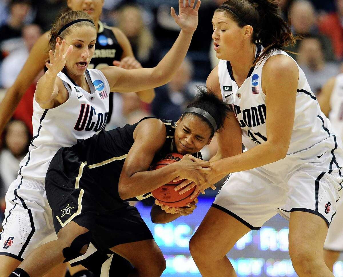 Connecticut's Caroline Doty, left, and teammate Stefanie Dolson, right, pressure Vanderbilt's Christina Foggie, center, in the first half of a second-round game in the women's NCAA college basketball tournament in Storrs, Conn., Monday, March 25, 2013. (AP Photo/Jessica Hill)