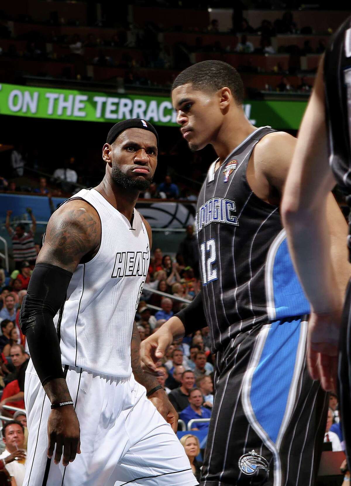 LeBron James stares down the Magic's Tobias Harris after a dunk.