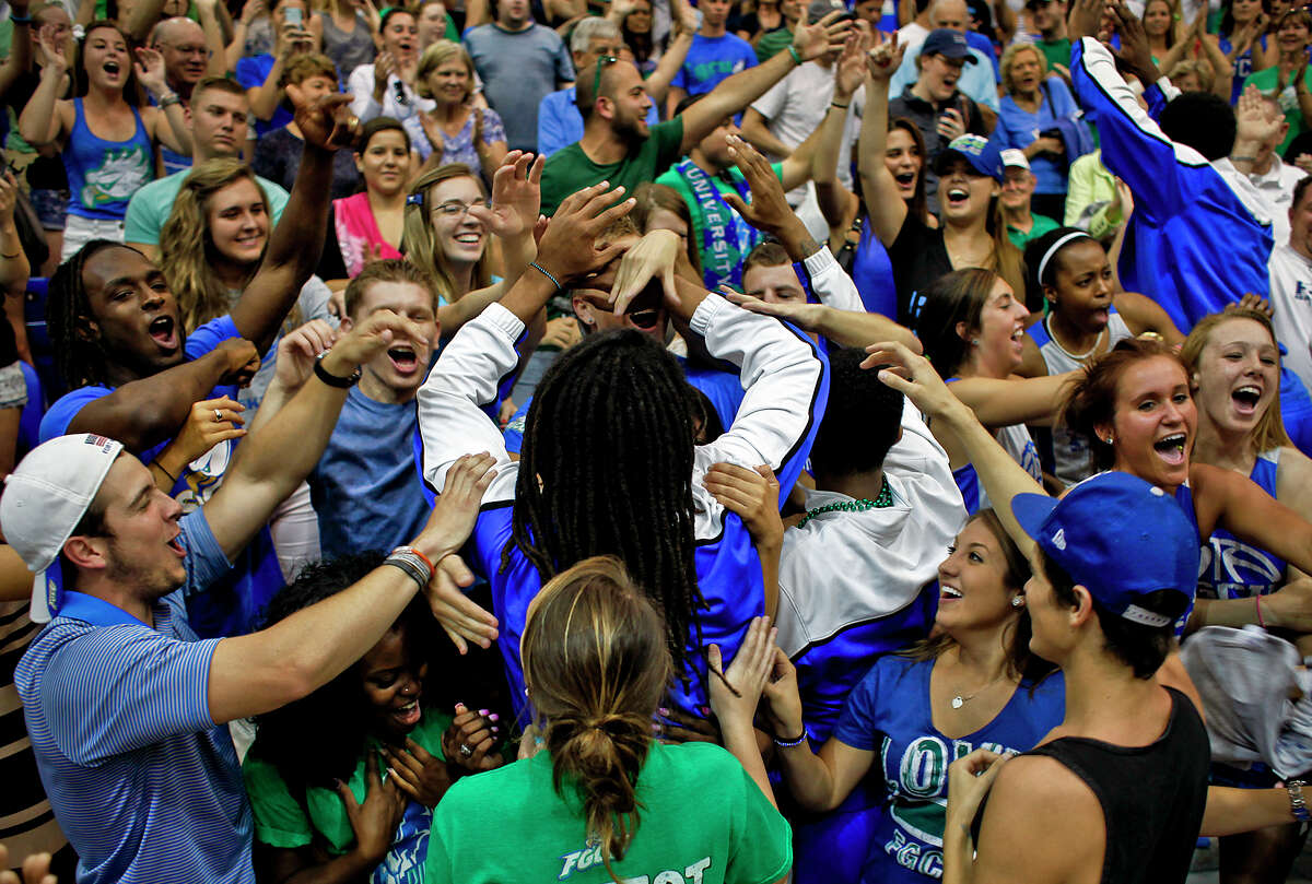 Florida Gulf Coast guard Sherwood Brown is surrounded by fans during a pep rally for the Eagles on the school's campus in Fort Myers, Fla.