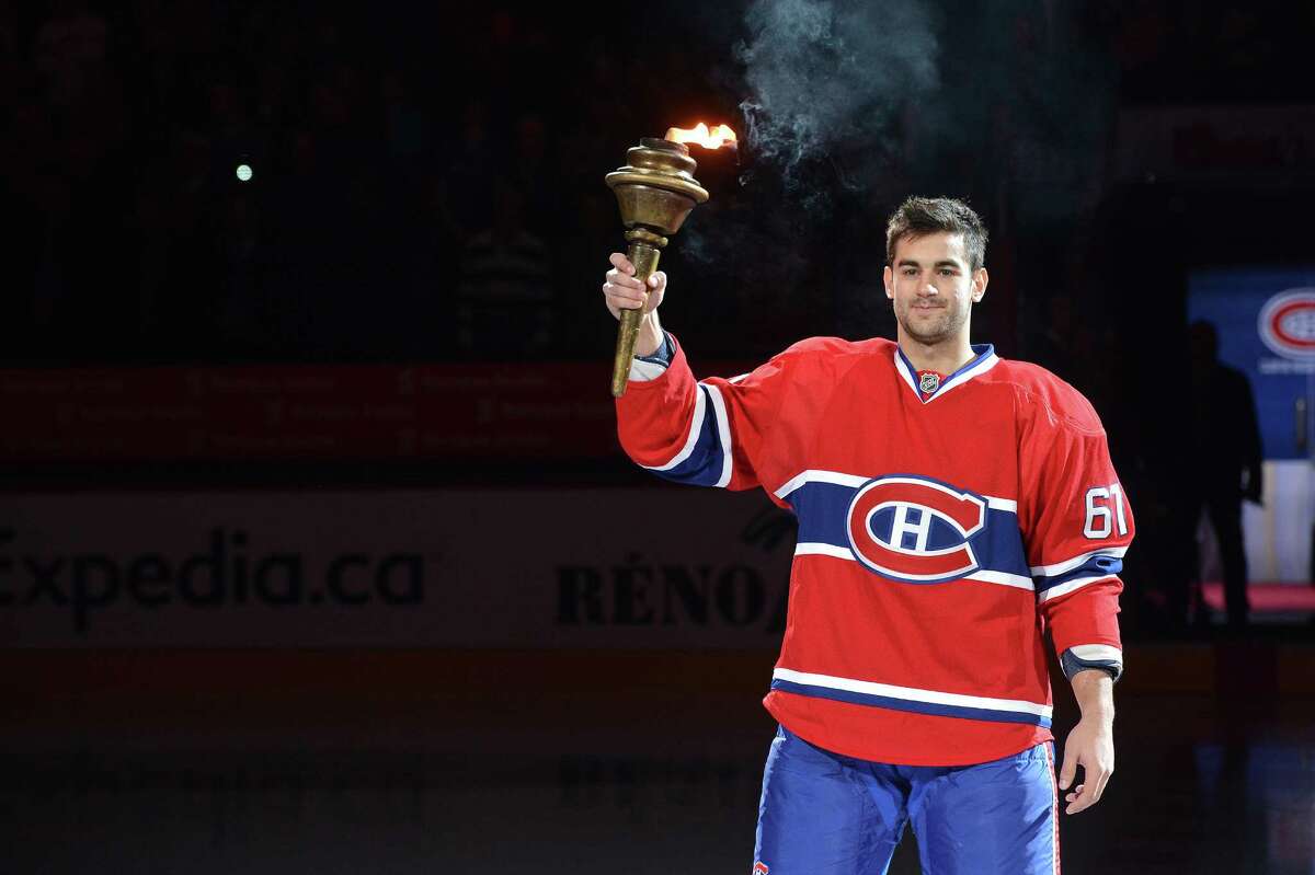 MONTREAL, CANADA - JANUARY 19: Max Pacioretty #67 raises the torch before the NHL opening game between the Montreal Canadiens and the Toronto Maple Leafs on January 19, 2013 at the Bell Centre in Montreal, Quebec, Canada. (Photo by Francois Lacasse/NHLI via Getty Images)