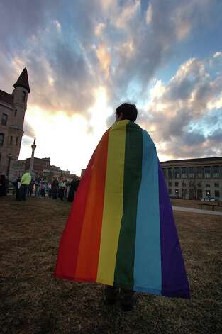 Daniel Wales, 21, of Clarks Summit, Pa. wears a Pride flag ...
