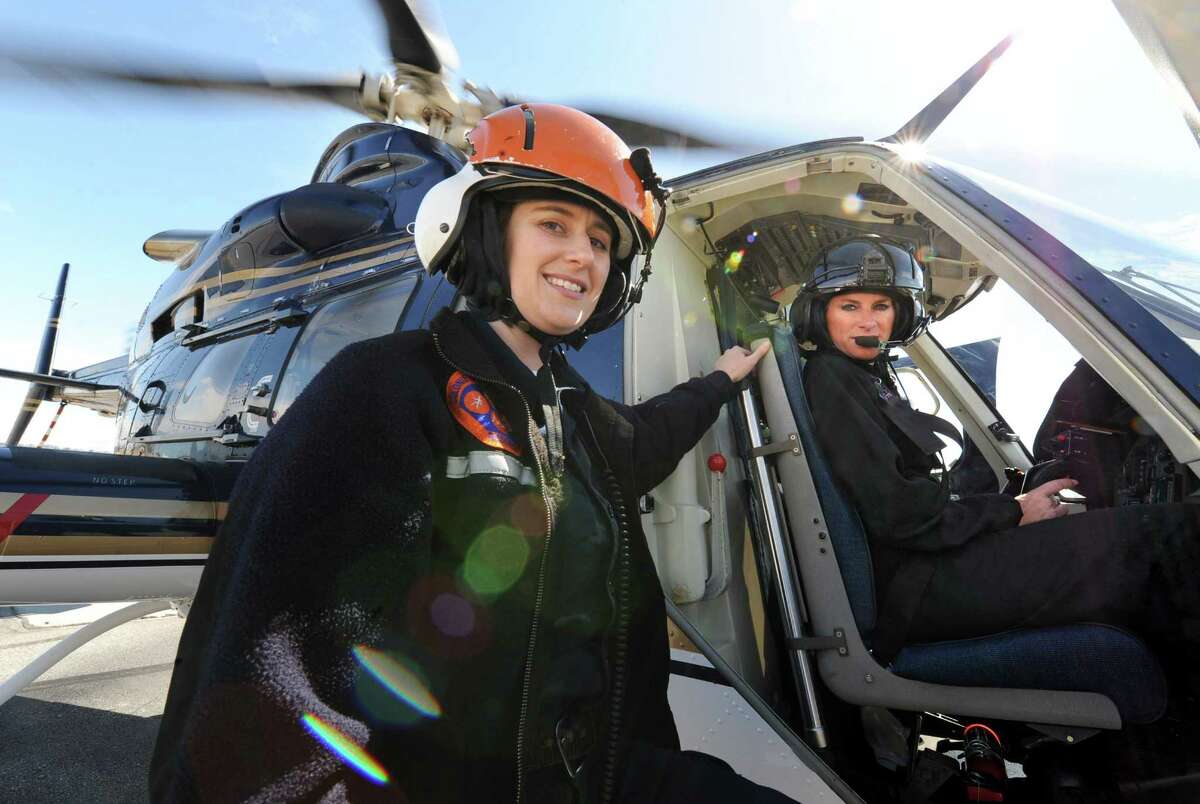 Colonie paramedic Mary Pat Provost and Kathy Humphries, Tech Sgt. with the NYS police, with a helicopter on Wednesday, March 27, 2013 in Colonie, N.Y. Tech Sgt. Humphries recently made New York State Police history when she piloted an all female medevac flight mission. On that mission were two female paramedics from Colonie, Mary Pat Provost, left, and Mary Beth Pulver, not pictured. Humphries is the first and only female NYS Police helicopter pilot. The former U.S. army pilot has been with the state police for 18 years.(Lori Van Buren / Times Union)