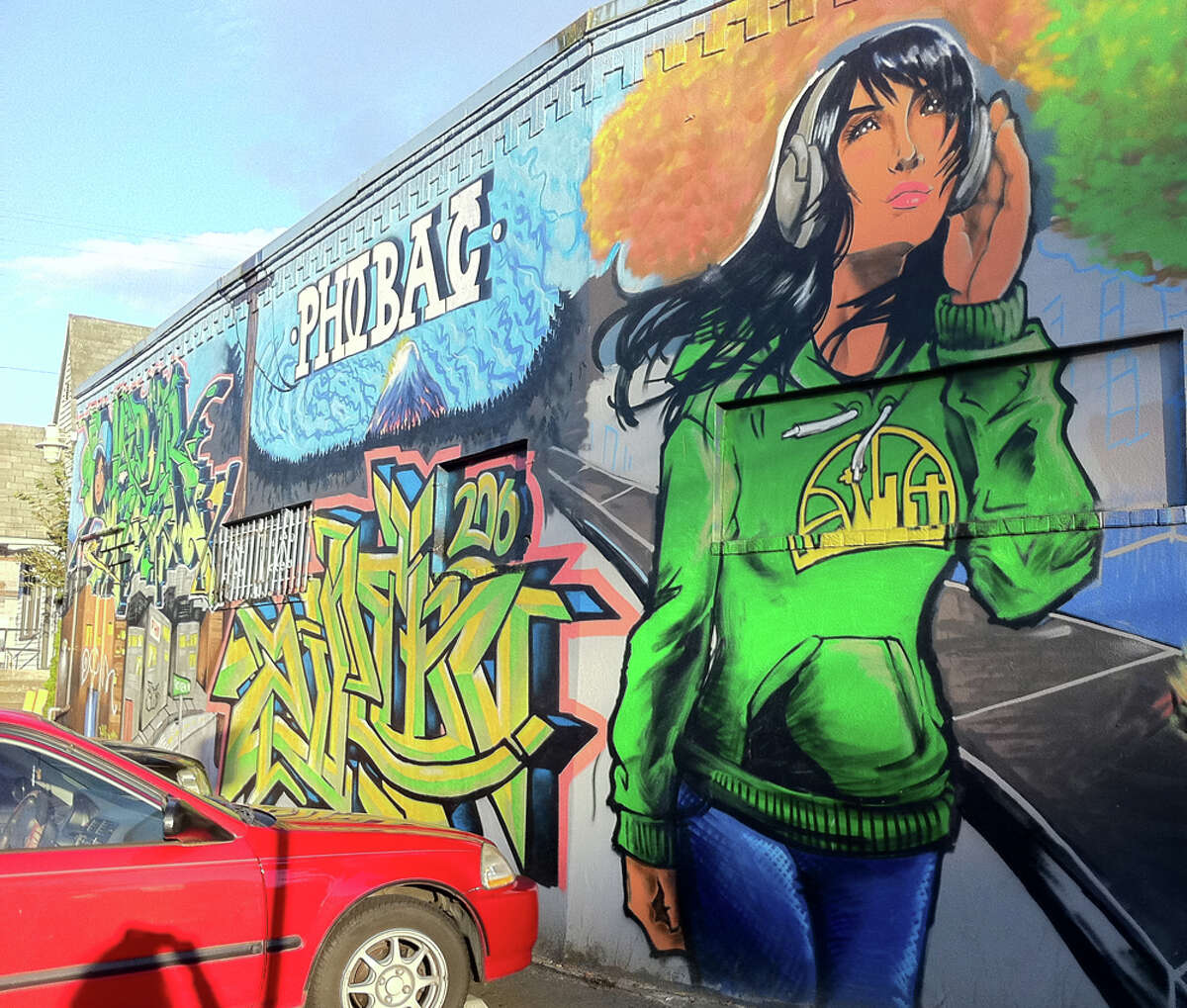 1. Can’t go wrong with a beautiful woman rocking an emerald-green, old-school Sonics hoodie. This mural enlivens the wall of Pho Bac on Rainier Avenue South. (seattlepi.com photo).