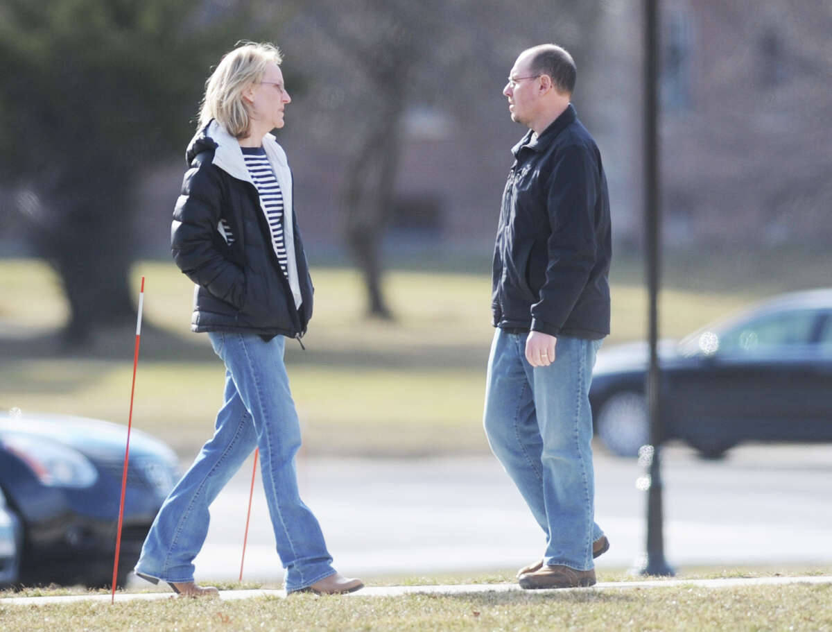 Two people arrive at the Newtown Municipal Center for the state police debriefing for families involved in the Sandy Hook shooting in Newtown, Conn. on Wednesday, March 27, 2013.