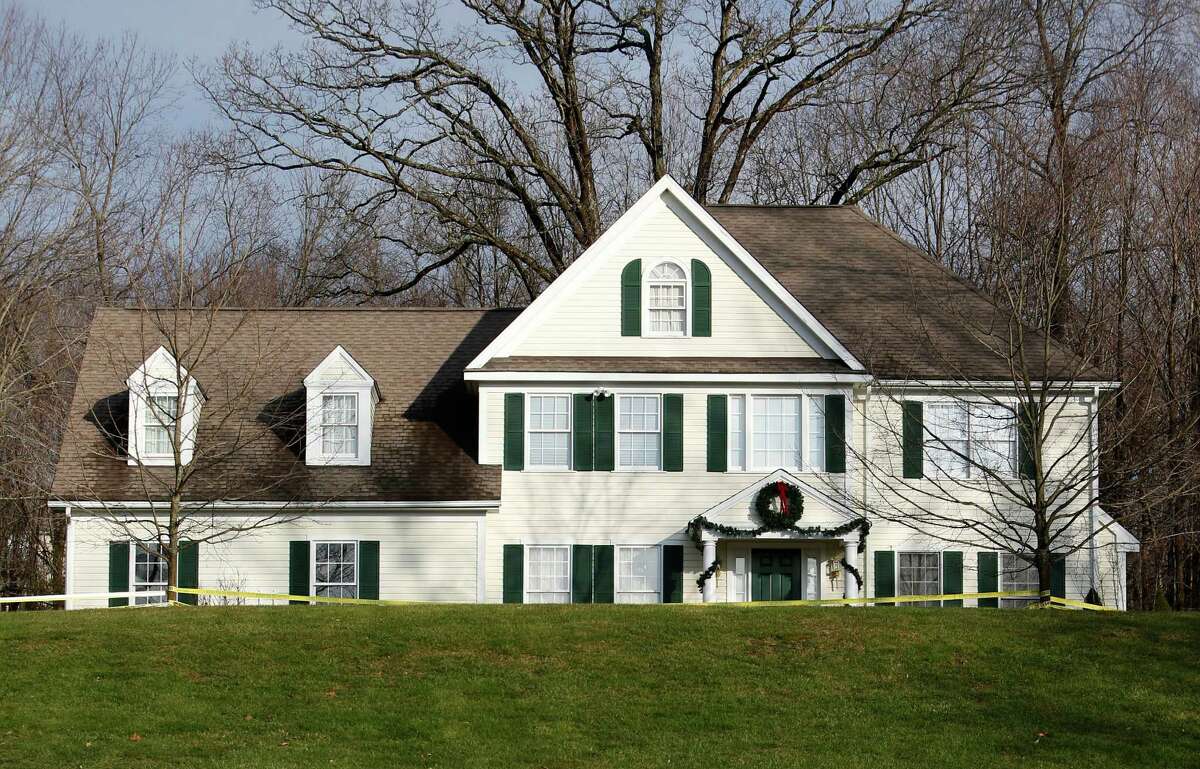 Crime scene tape surrounds the home of Nancy Lanza, Tuesday, Dec. 18, 2012, in Newtown, Conn. Nancy Lanza was killed by her son Adam Lanza before he forced his way into Sandy Hook Elementary School in Newtown Friday and opened fire, killing many others, including 20 children.