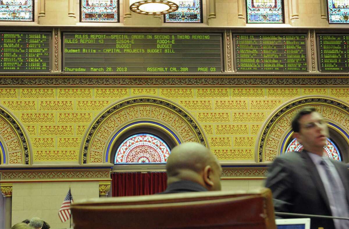 Members of the Assembly work at their desks as they debate and vote on budget bills on the floor of the State Assembly on Thursday, March 28, 2013 in Albany, NY. (Paul Buckowski / Times Union)