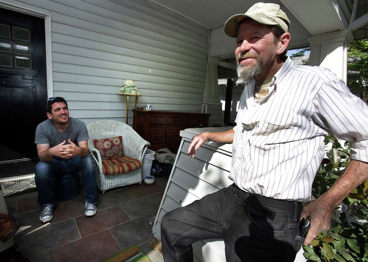Gavin Rogers (left) sits on his front porch with Willie Schooman, who was formerly homeless.