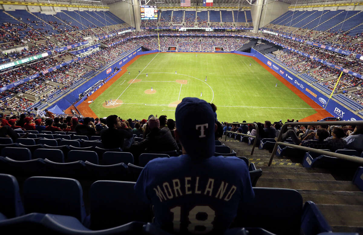 Baseball fan John Heridia watches the Texas Rangers and San Diego Padres exhibition baseball game part of the Big League Weekend Friday March 29, 2013 at the Alamodome.