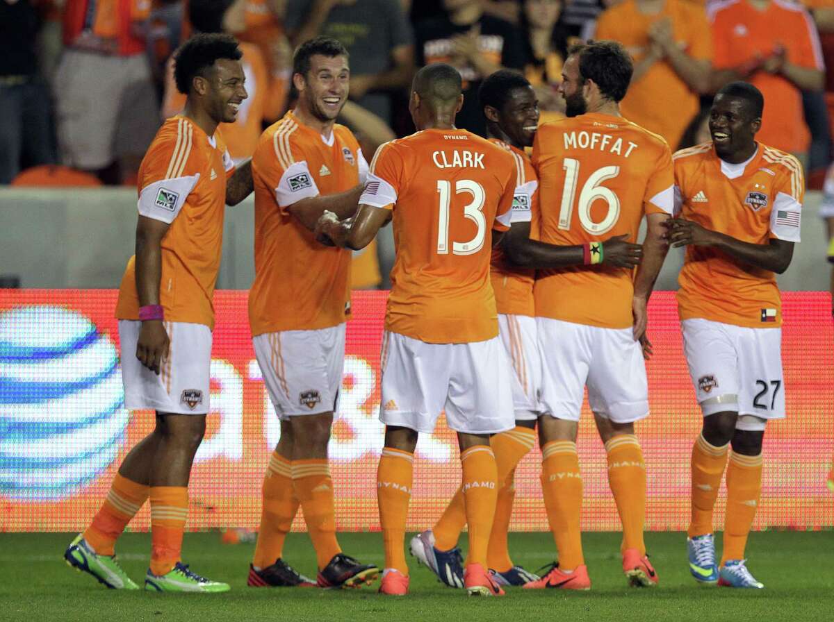 Houston Dynamo players celebrate after a goal by the Houston Dynamo forward Will Bruin 2nd from right, during the first half of MLS soccer game action at BBVA Compass Stadium Saturday, March 30, 2013, in Houston .