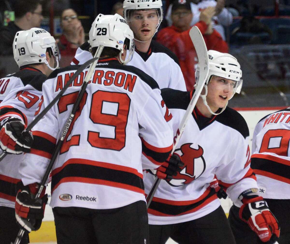Albany Devils' #20 Reid Boucher, at right, and team mates celebrate his first period goal during Saturday's game against the Portland Pirates at the Times Union Center in Albany March 30, 2013. (John Carl D'Annibale / Times Union)