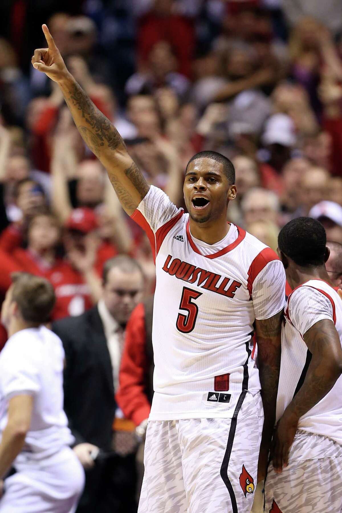INDIANAPOLIS, IN - MARCH 31: Chane Behanan (wearing the #5 jersey belonging to teammate Kevin Ware) #21 of the Louisville Cardinals celebrates late in the second half against the Duke Blue Devils during the Midwest Regional Final round of the 2013 NCAA Men's Basketball Tournament at Lucas Oil Stadium on March 31, 2013 in Indianapolis, Indiana. Ware suffered a compound leg fracture in the first half. (Photo by Andy Lyons/Getty Images)