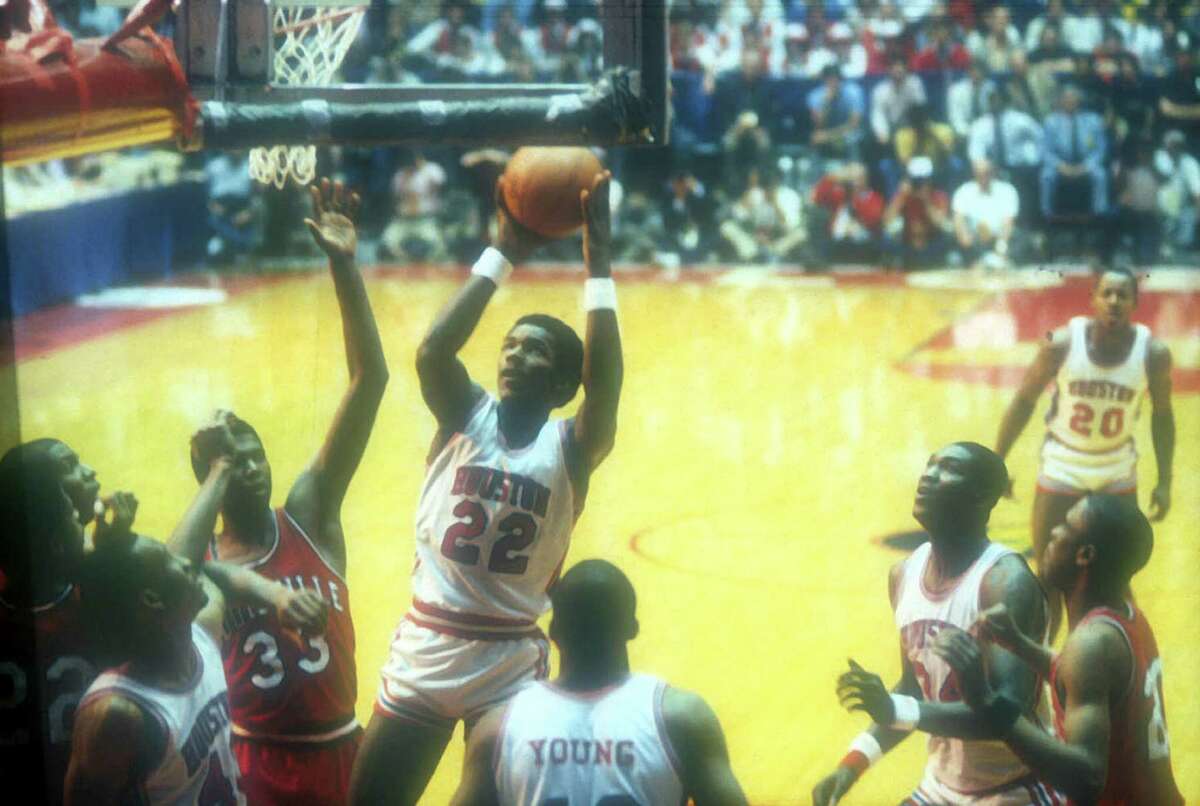 Clyde Drexler (22) and his 1983 Houston Cougars would slam the door shut on the 1990 UT team, Tim Griffin says.