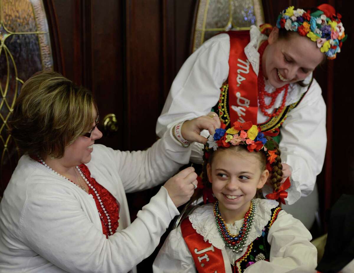 Sherry Ryczek, left, works on her daughter Julianna Ryczek's costume with the help of Brenda Dudas, right, before she dances with the St. Adelbert's Dance Group during the Dyngus Day celebration April 1, 2013, at the Elks lodge in Rotterdam, N.Y. (Skip Dickstein/Times Union)