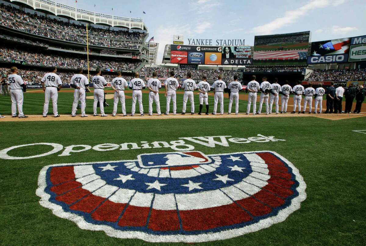 New York Yankees players line up on the baseline during introductions and a tribute to the Newtown, Ct., school shooting victims at an Opening Day baseball game at Yankee Stadium in New York, Monday, April 1, 2013.