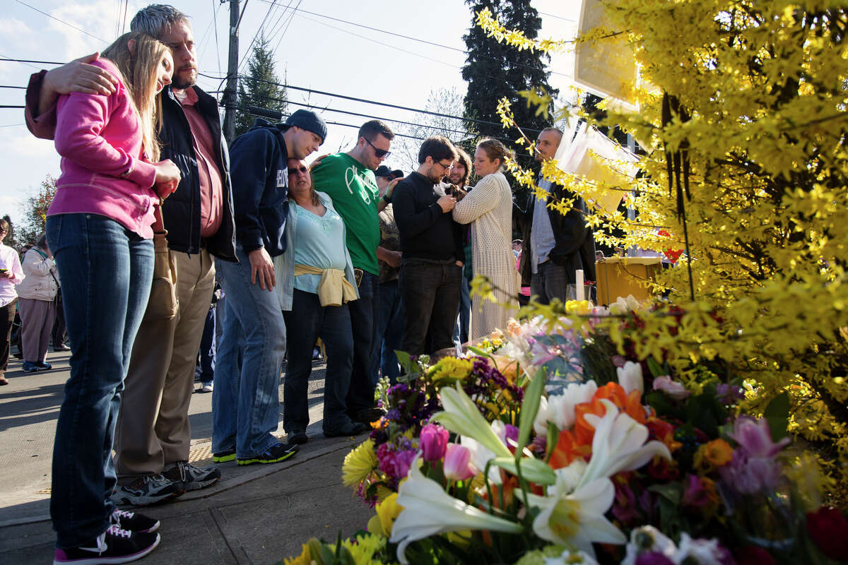 A range of relatives from cousins to siblings of Dennis and Judy Schulte gather at the site of their relatives' death during a memorial walk Monday, April 1, 2013, in the Wedgwood neighborhood of Seattle. The timing of the march marked one week since Judy and Dennis Schulte lost their lives to a suspected drunken driver while crossing Northeast 75th Street at 33rd Avenue Northeast with their daughter-in-law, Karina Ulriksen-Schulte, and her then 10-day-old son, Elias. (Jordan Stead, seattlepi.com)