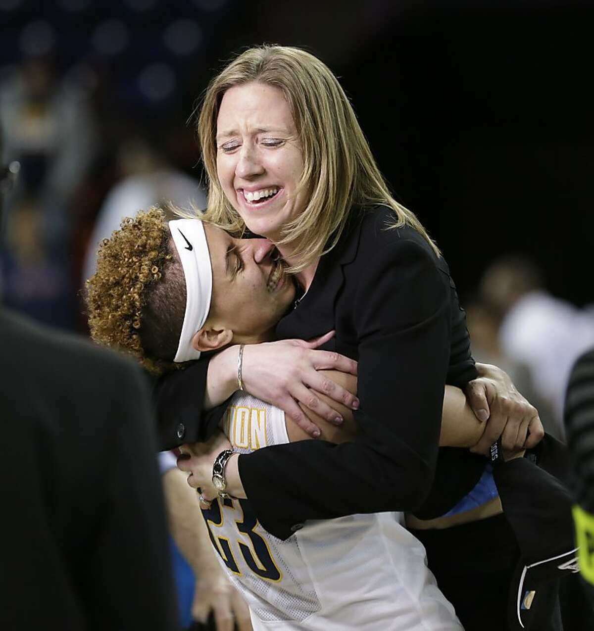 California head coach Lindsay Gottlieb, right, is embraced by Layshia Clarendon after the team beat Georgia in overtime in a regional final in the NCAA women's college basketball tournament, Monday, April 1, 2013, in Spokane, Wash. Cal won 65-62. (AP Photo/Elaine Thompson)