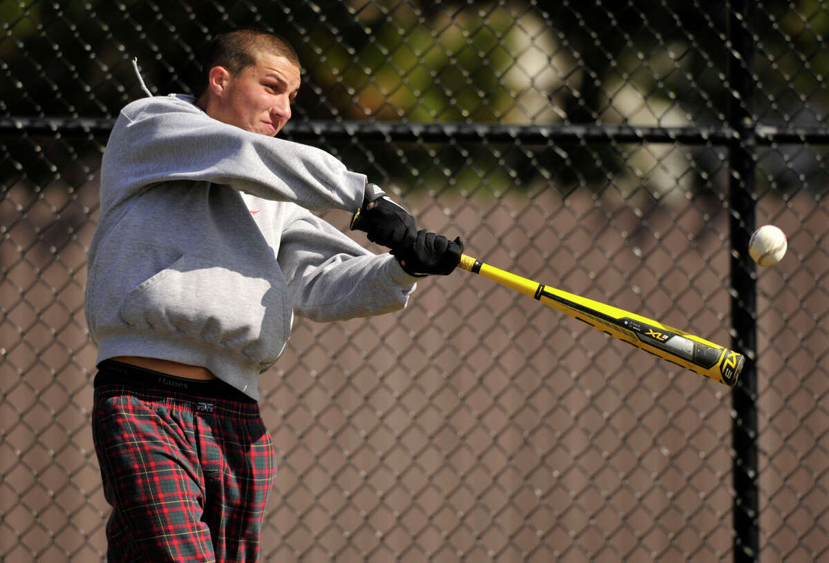 Team co-captain Paul Battinelli connects with the ball during batting practice at Stamford High School on Tuesday, April 2, 2013.