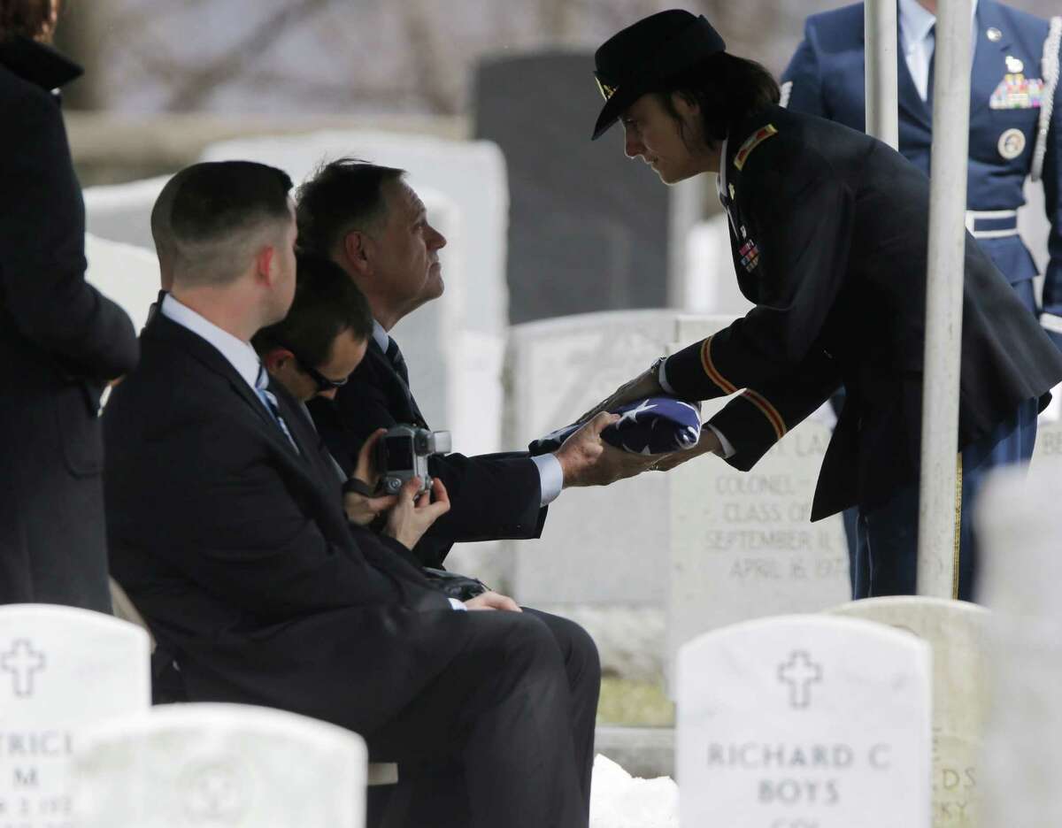 Col. Cindy Jebb, right, presents a flag to David Strong during a burial service at the West Point Cemetery on Friday, March 22, 2013, in West Point, N.Y. The service was for Strong's parents Maj. Gen. Robert Strong and Virginia Strong. Graves of soldiers from every U.S. war make this small plot of the land the most hallowed ground on the nation's the most venerable military academy. And after 196 years and more than 8,000 souls, it's close to full.