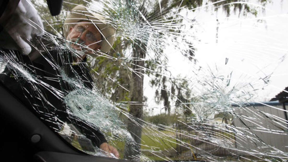 Bob Paulson, of Hondo, Texas, checks on hail damage on a truck while it was parked at the Bostonian Inn & Suites on Wednesday, March, 3, 2013, in Hitchcock, Texas. (Nick de la Torre / Houston Chronicle)