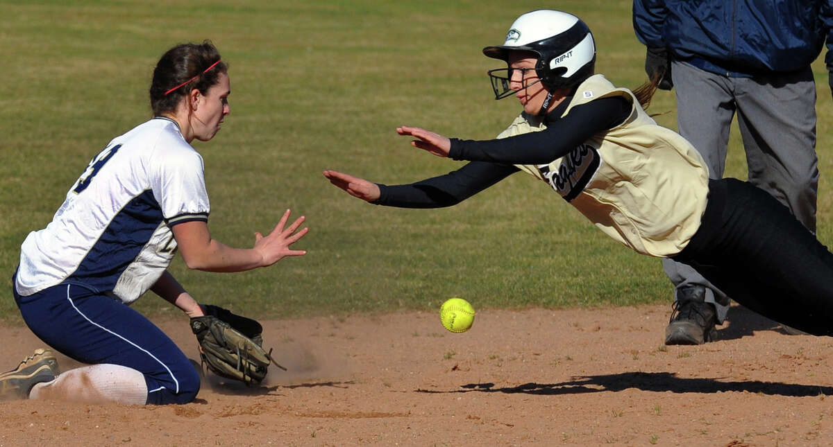 Trumbull's Christie Costello dives into second as Lauralton Hall shortstop Maureen Connolly tries to make the tag, during softball action in Milford, Conn. on Wednesday April 3, 2013.