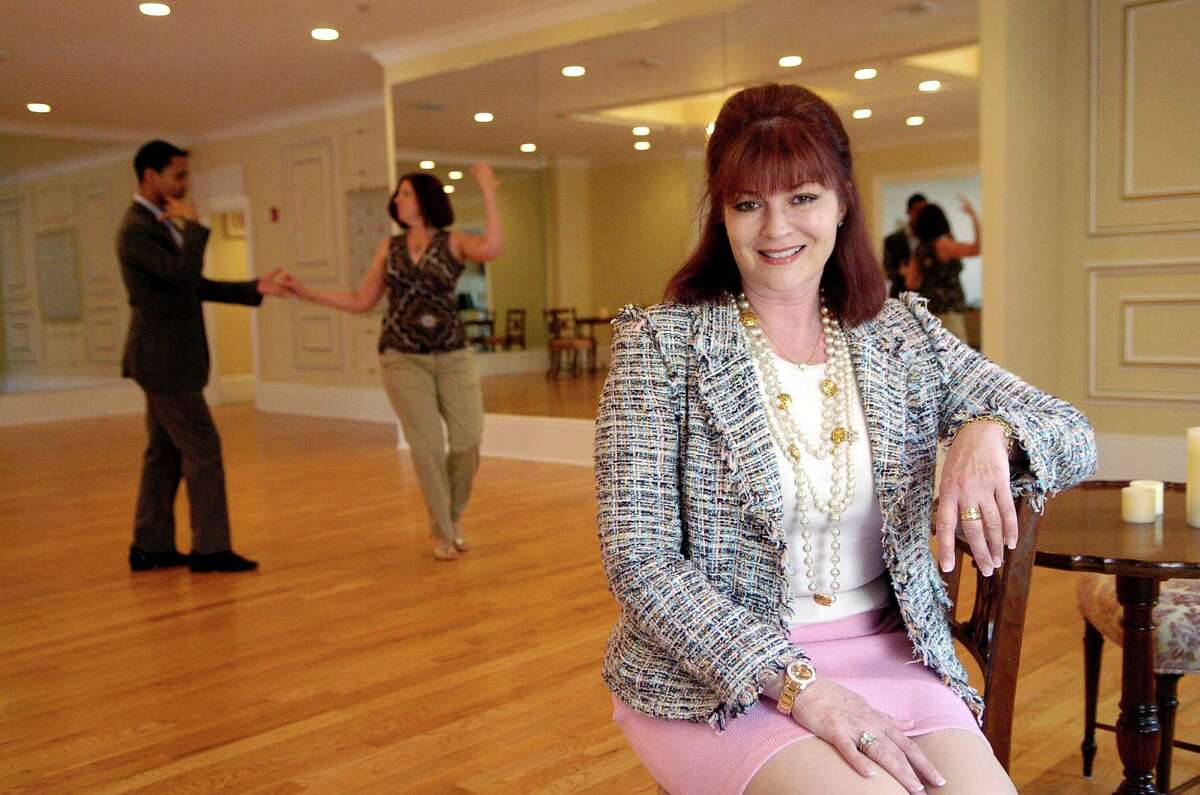 Christine Georgopulo, who recently bought the Arthur Murray Studio and remodeled it, poses in the Arthur Murray Grande Ballroom of Greenwich in 2011 as instructor Mario Moreta works with student Julie Willstatter.