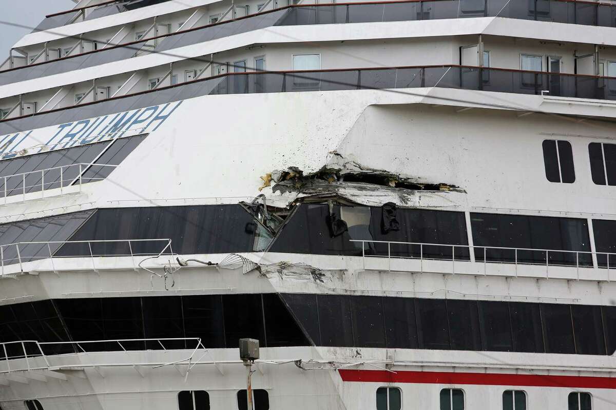 The Carnival cruise ship Triumph rests against a dock after it tore loose from its mooring Wednesday at the BAE Shipyard in Mobile, Ala. The ship sustained a 20-foot gash when it struck a cargo vessel.
