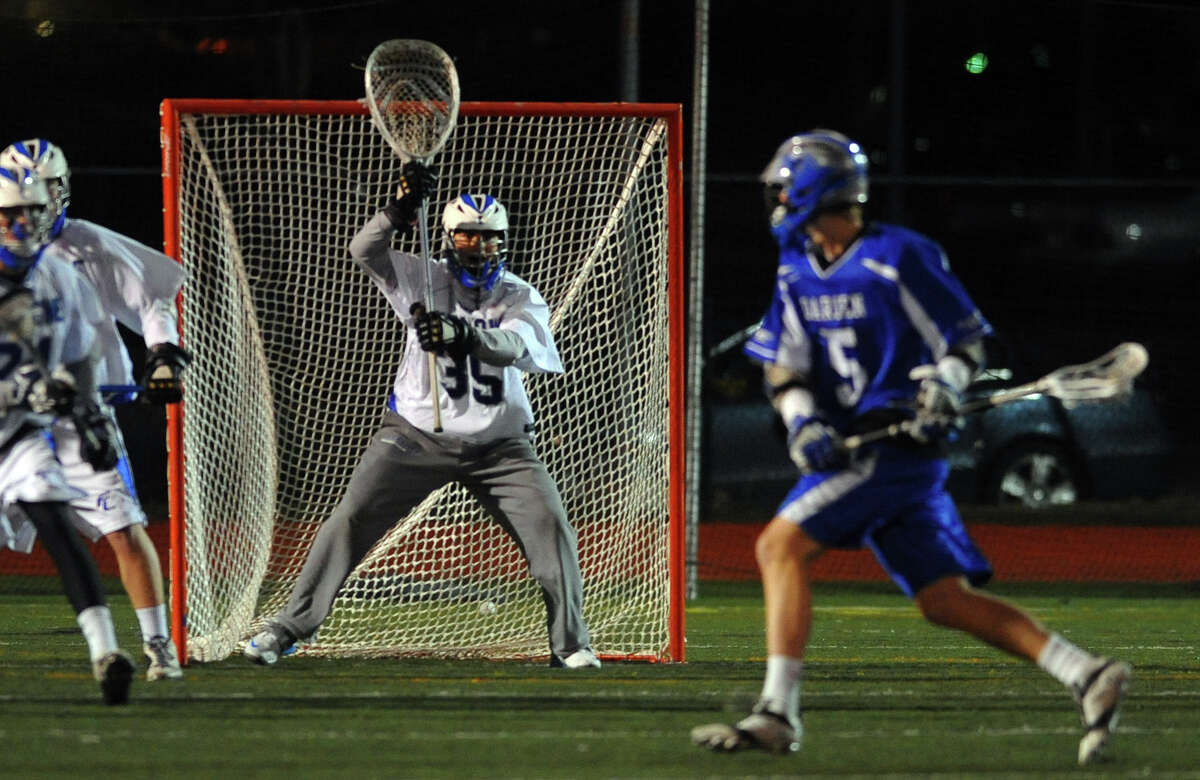 Fairfield Ludlowe goalie Tom Kryspin gets ready for a drive by Darien's #5 Harry Gillespie, during boys lacrosse action in Fairfield, Conn. on Wednesday April 3, 2013.