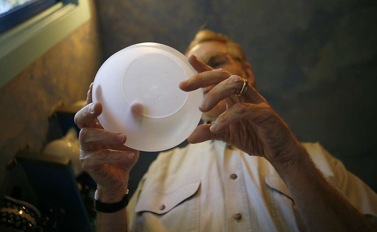 Orinda resident Greg Kelly looks for a number seven, which represents containers with BPA, on the bottom of a plastic bowl. Kelly is giving plastics in his kitchen a serious look after reading reports that BPA leaches into food.