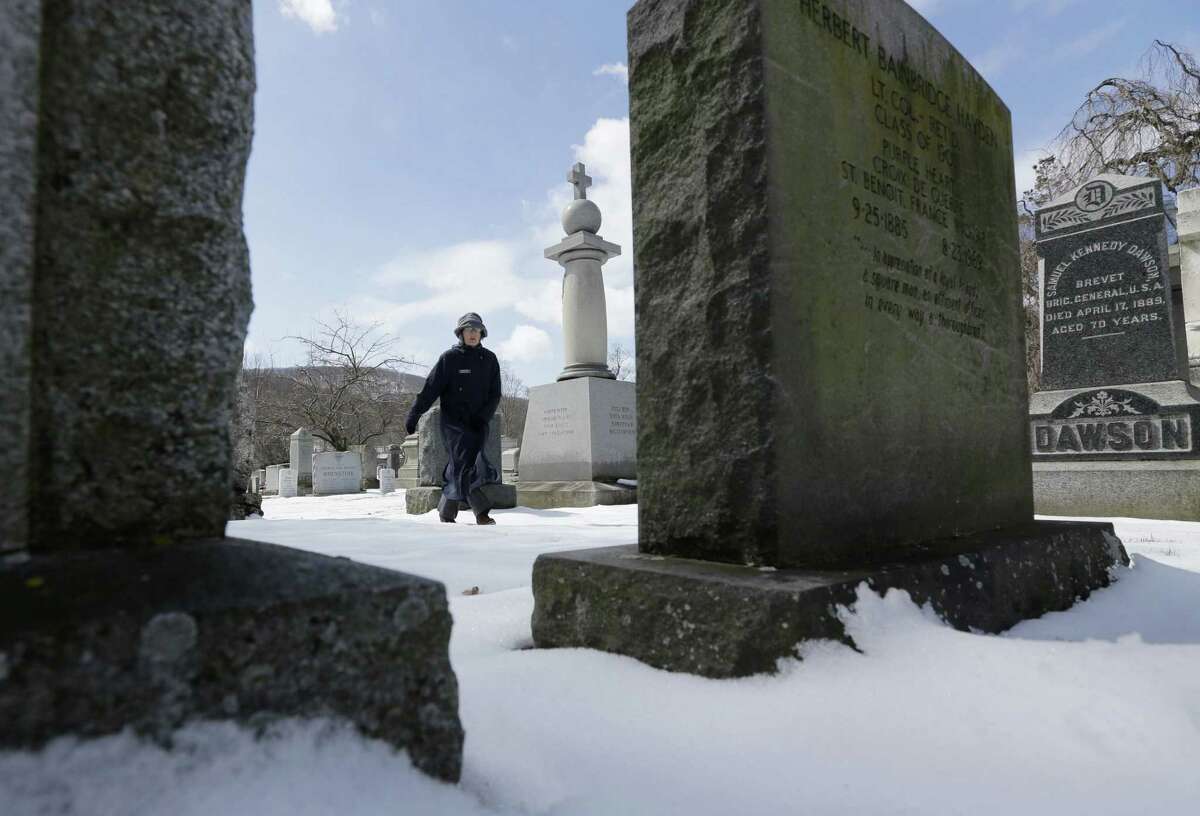 Administrator Kathleen Silvia, walking amid the West Point Cemetery gravestones, says, “I would challenge you to find more valor in a smaller amount of space.”