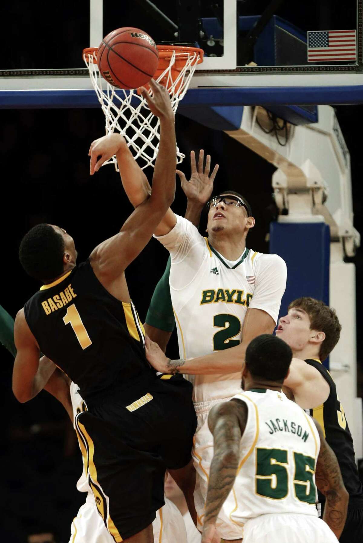 Baylor's Rico Gathers (2) rejects Iowa's Melsahn Basabe during the first half. Pierre Jackson's 17 points and 10 rebounds led the Bears to victory.