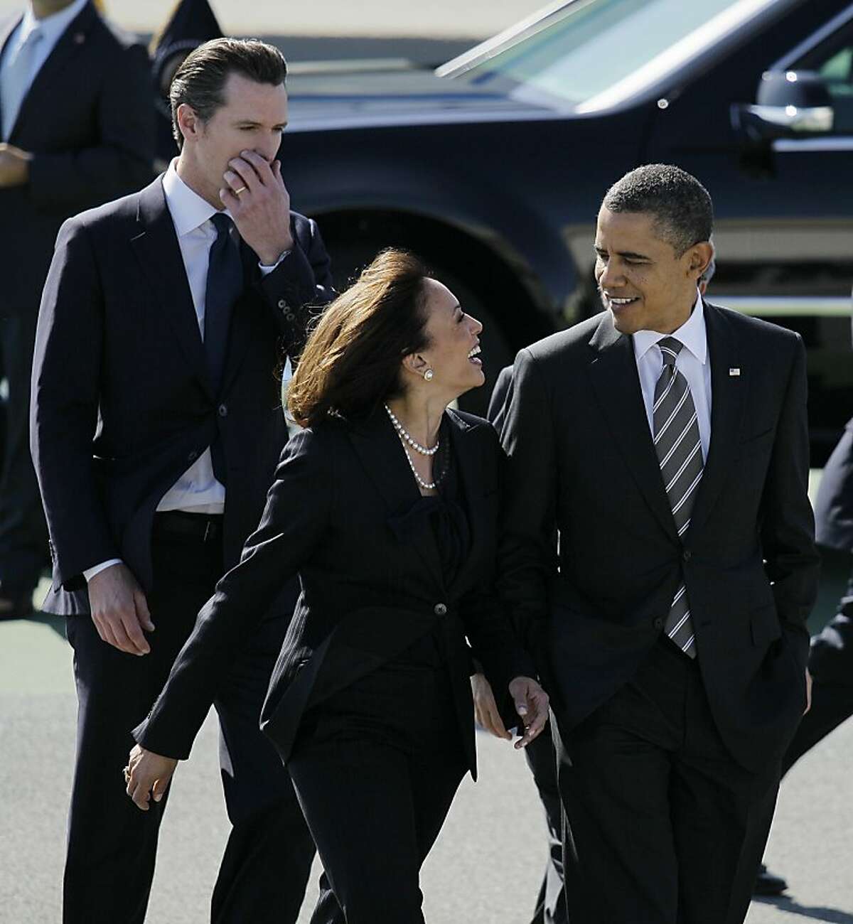FILE -- in this Feb. 16, 2012 file photo President Barack Obama walks with California Attorney General Kamala Harris, center, and California Lt. Gov. Gavin Newsom, after arriving at San Francisco International Airport in San Francisco. Obama praised California's attorney general for more than her smarts and toughness at a Democratic Party event Thursday, April 4, 2013. The president also commended Harris for being "the best-looking attorney general" during a Democratic fundraising lunch in the Silicon Valley. (AP Photo/Eric Risberg, File)