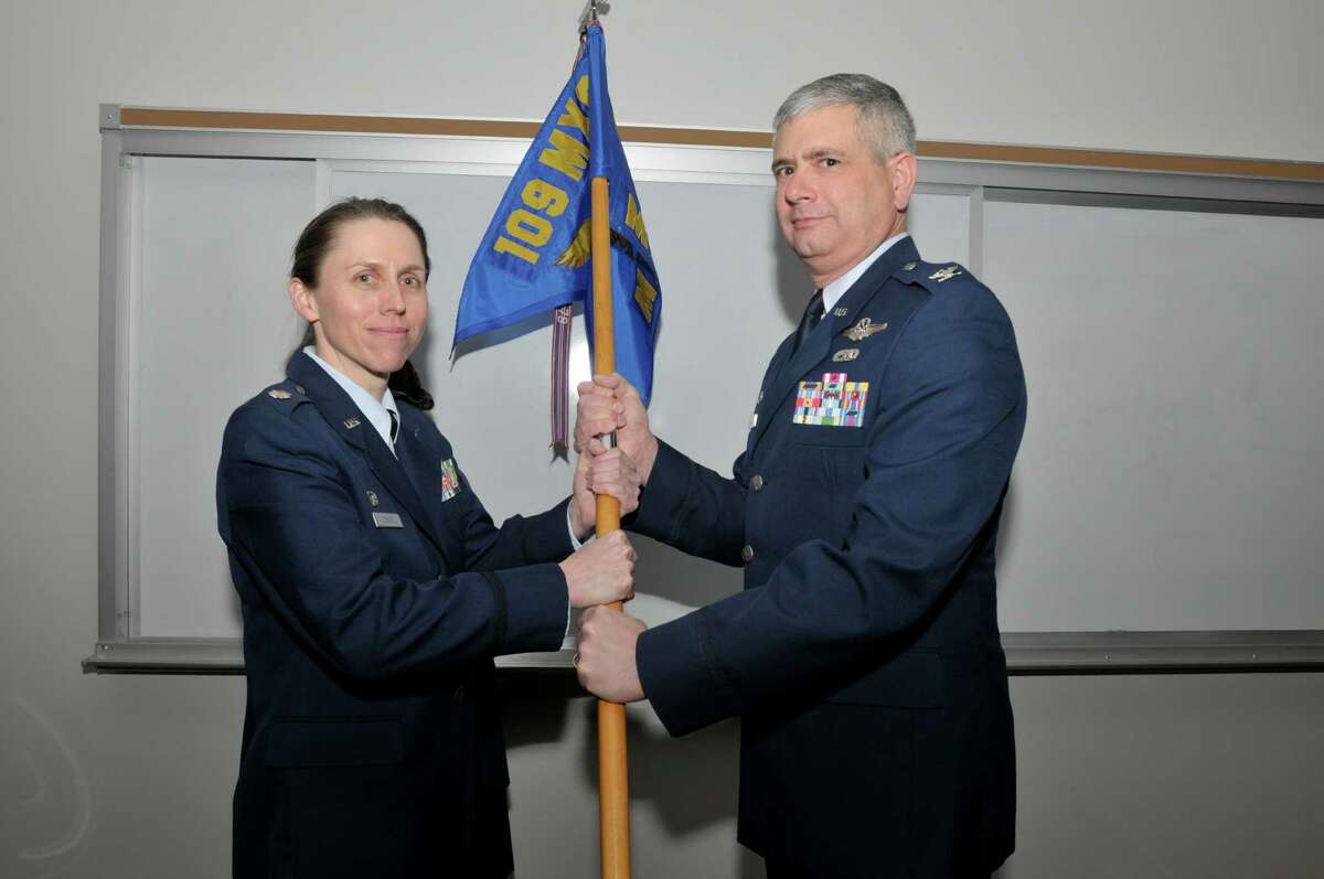 DIVISION OF MILITARY AND NAVAL AFFAIRS Air National Guard Lt. Col. Denise Donnell accepts the flag of the 109th Maintenance Group from 109th Airlift Wing Commander Col. Shawn Clouthier during a change of command ceremony.