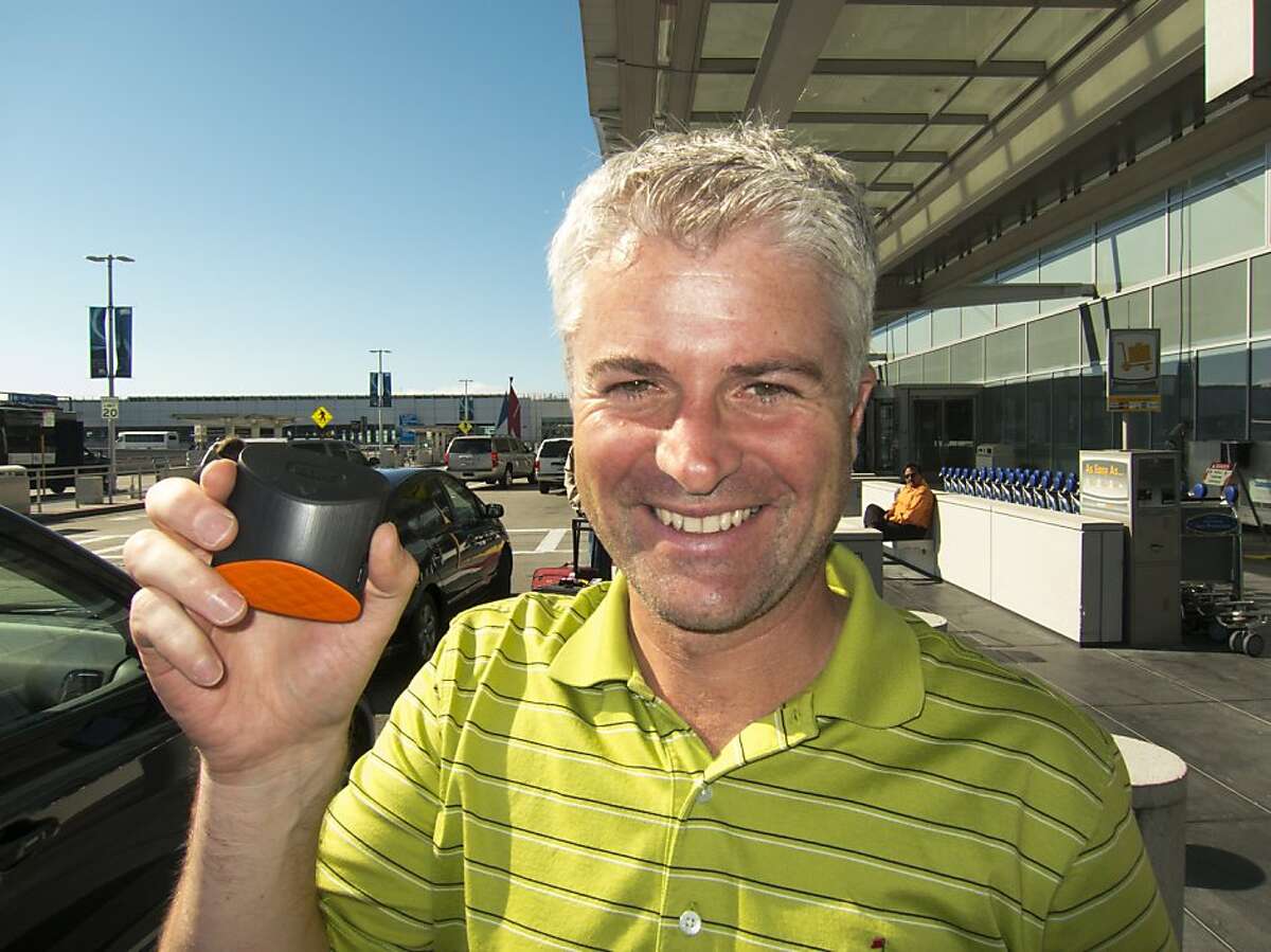 CEO John McGuire holds up the Game Golf device which tracks your golfing performance.