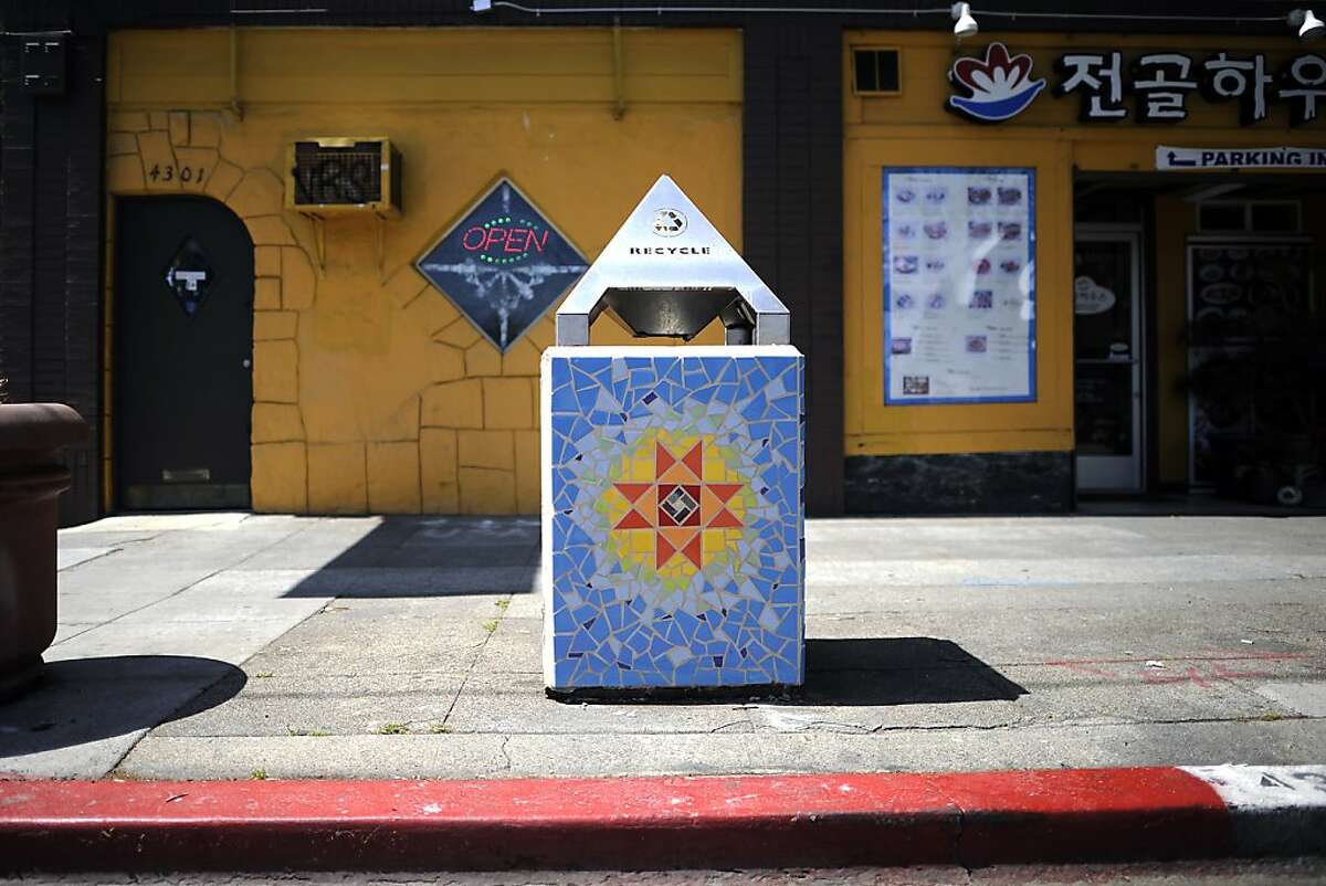 Trash cans covered with tile mosaic art are seen on Telegraph Ave. in the Temescal district of Oakland, CA Wednesday April 3rd, 2013.