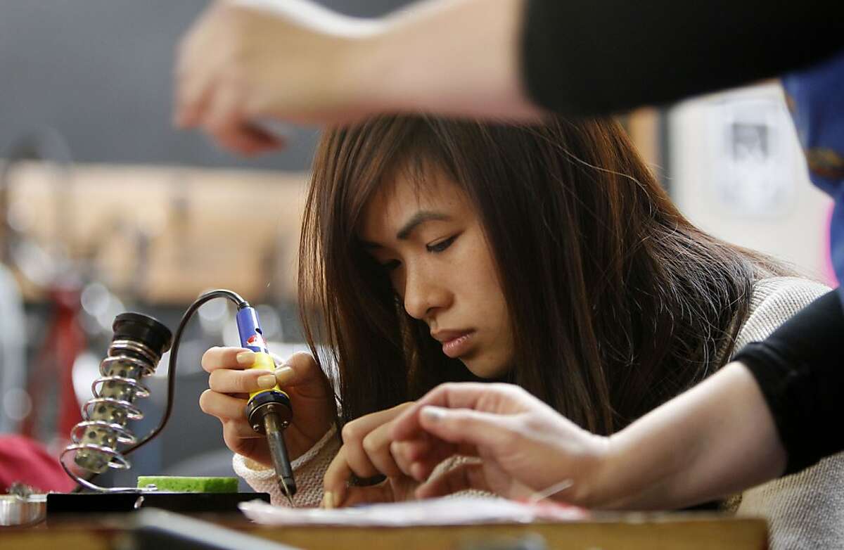 Twelfth grader Jamie Guan, builds her LED flashing light project as students from Burton High School get a hands on experience in electronics and physics at Noisebridge, in San Francisco, Ca. on Tuesday April 2, 2013. Noisebridge is an infrastructure provider for technical-creative projects, collaboratively run by its members as a non-profit educational corporation for public benefit.