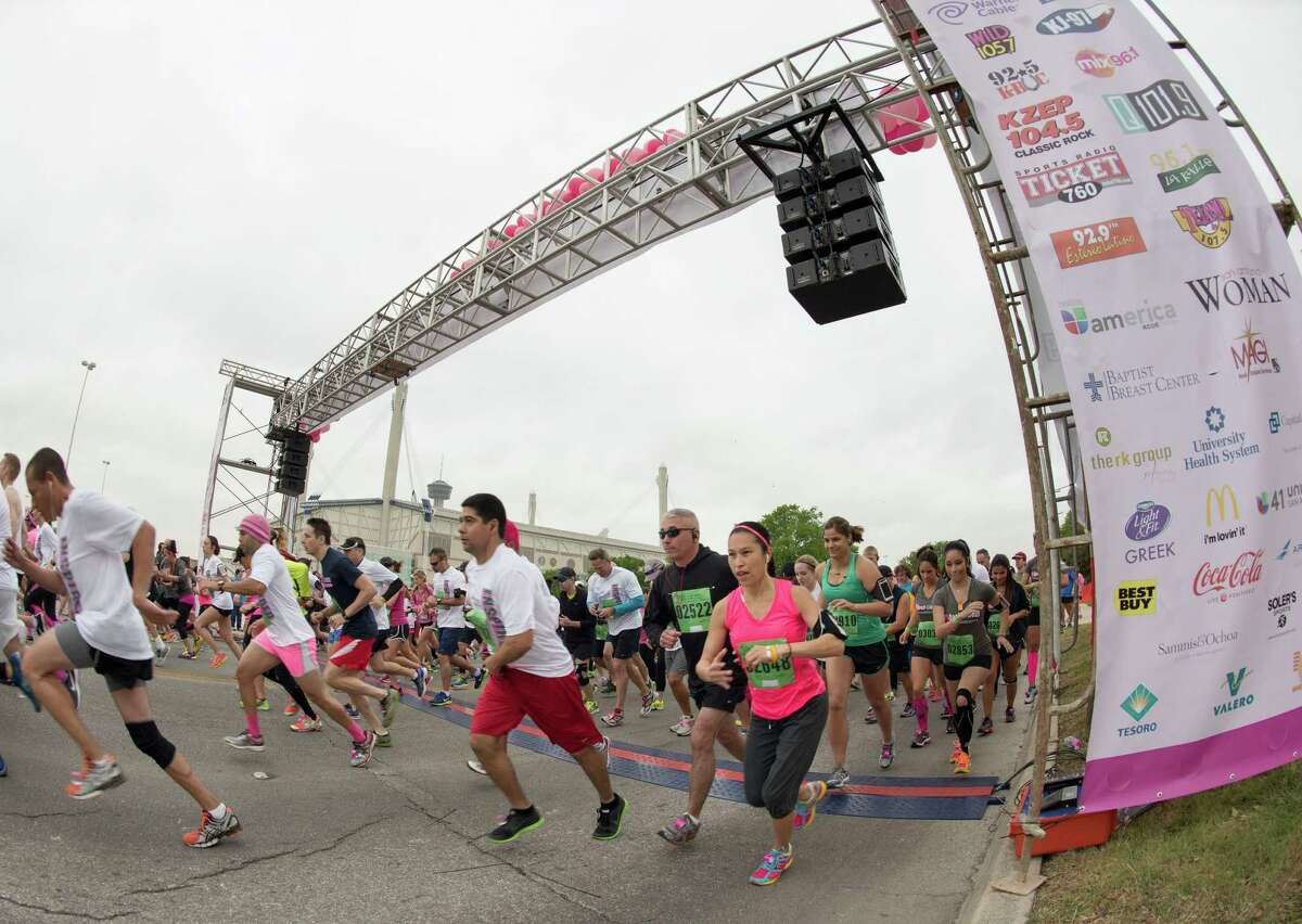 Participants leave the starting line during the Susan G. Komen Race for the Cure, Saturday, April 6, 2013, in San Antonio. (Darren Abate/For the Express-News)