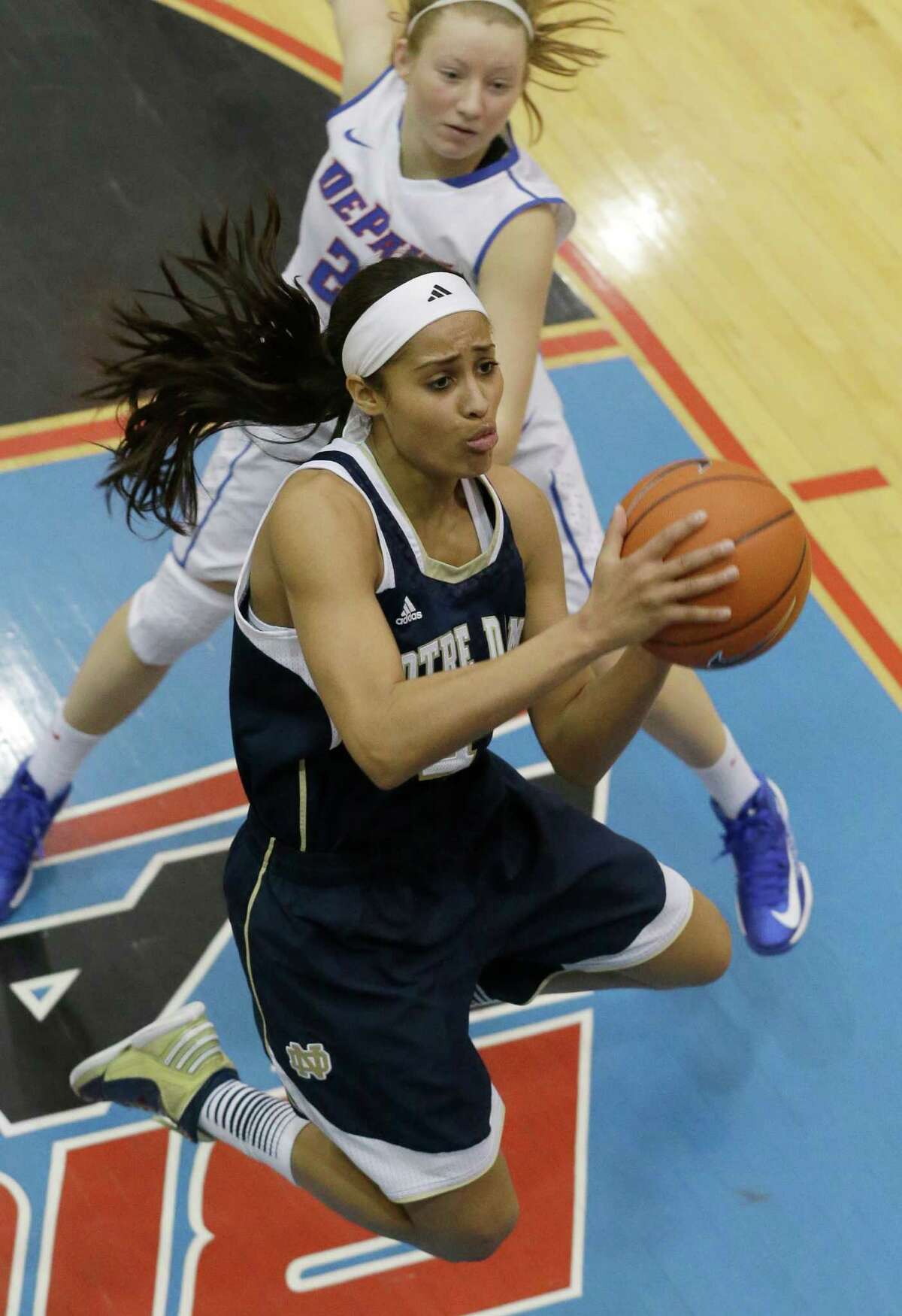 Notre Dame guard Skylar Diggins (4) drives to the basket past DePaul guard Megan Rogowski (21) during the second half of an NCAA women's college basketball game in Chicago on Sunday, Feb. 24, 2013 .Notre Dame won 84-56. (AP Photo/Nam Y. Huh)