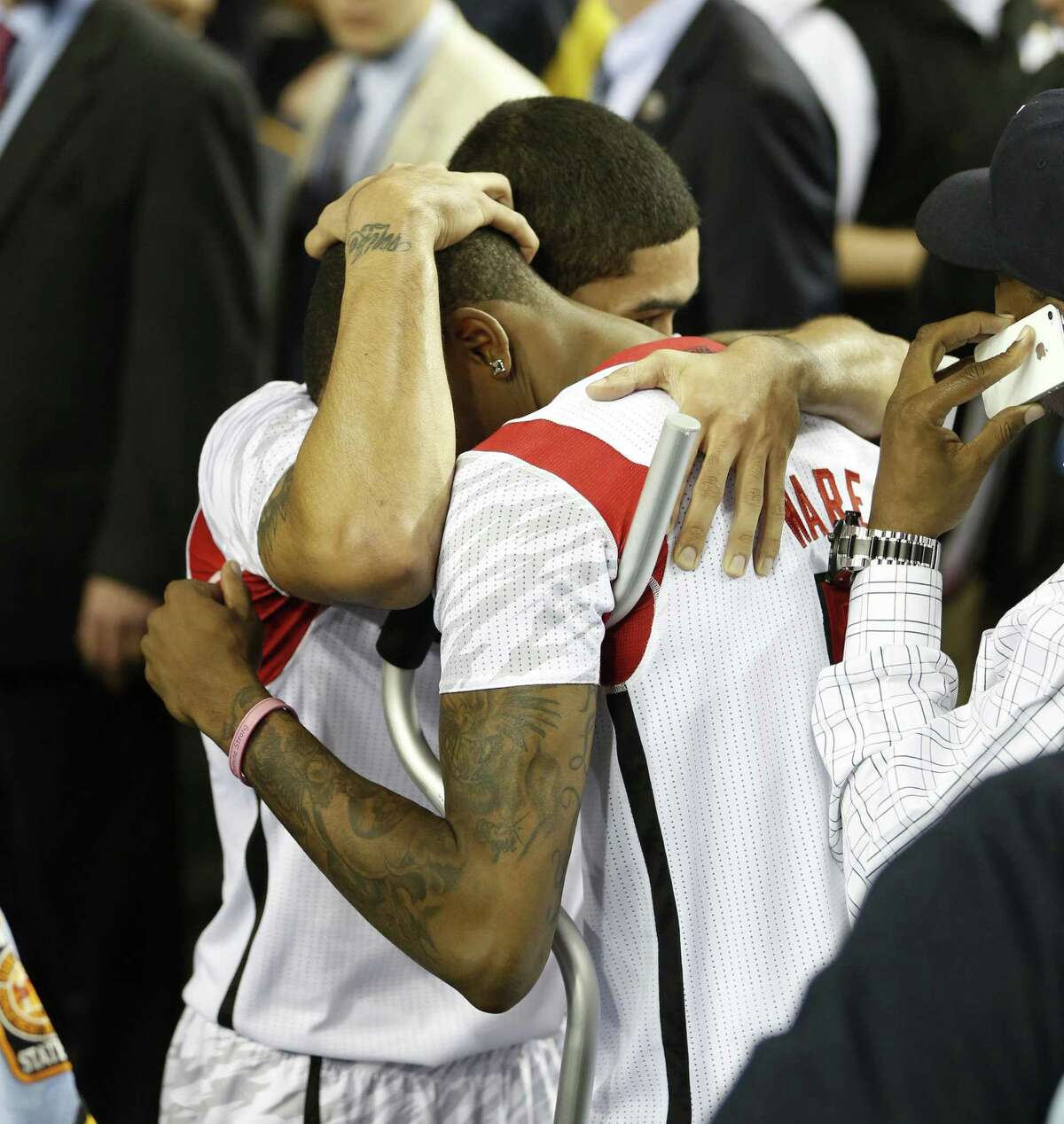 Peyton Siva (left) hugs injured teammate Kevin Ware after Louisville won Saturday.